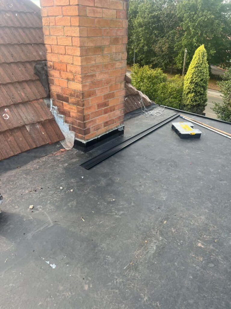 This is a photo of a flat roof which has just been repaired, there is also a chimney stack and some leadwork has also been dressed. Works carried out by Swanley Roofing Repairs